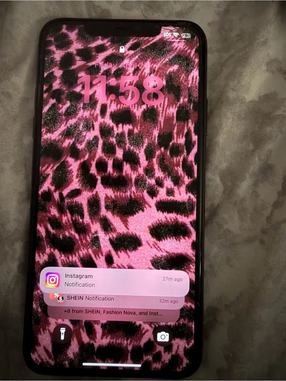 Apple iPhone with Pink Leopard Print Wallpaper and Black Case